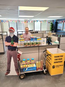 2019 — Holiday food drive, Len Scavuzzo holding some of the donated goods